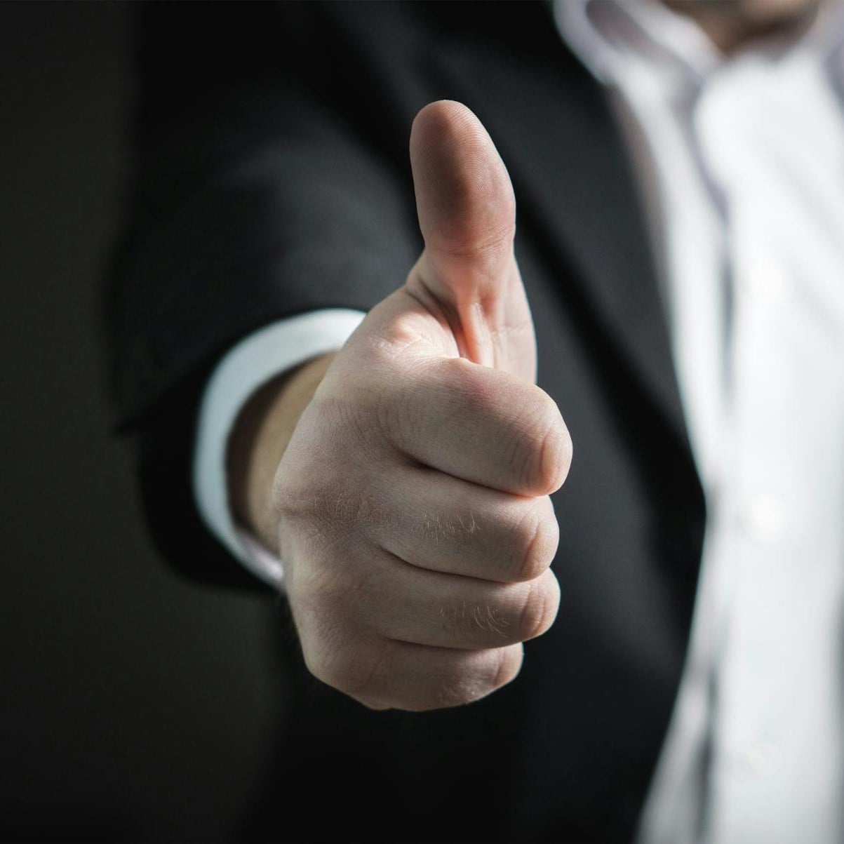 man giving thumbs up depicting excellence