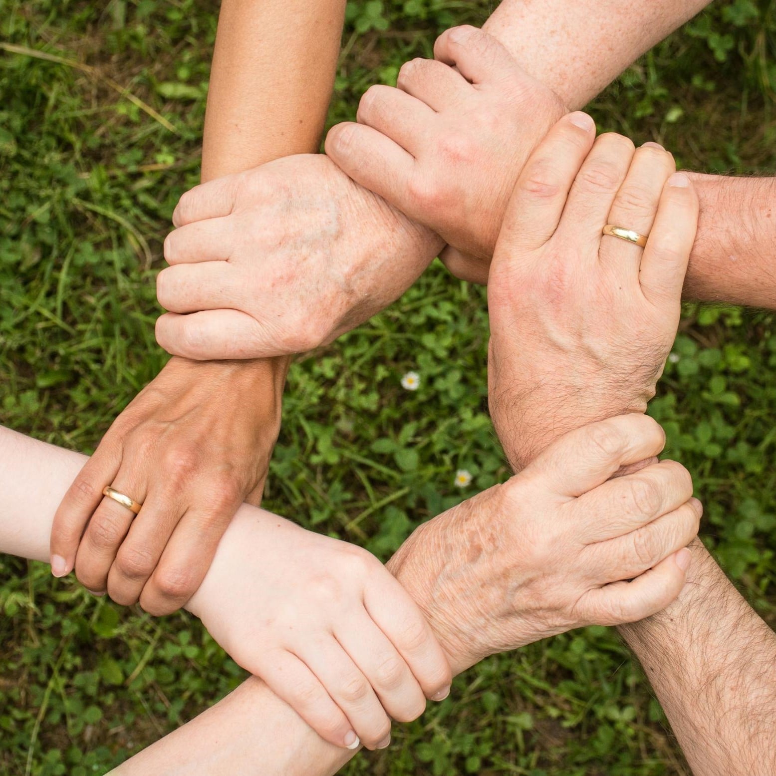 six hands together depicting community